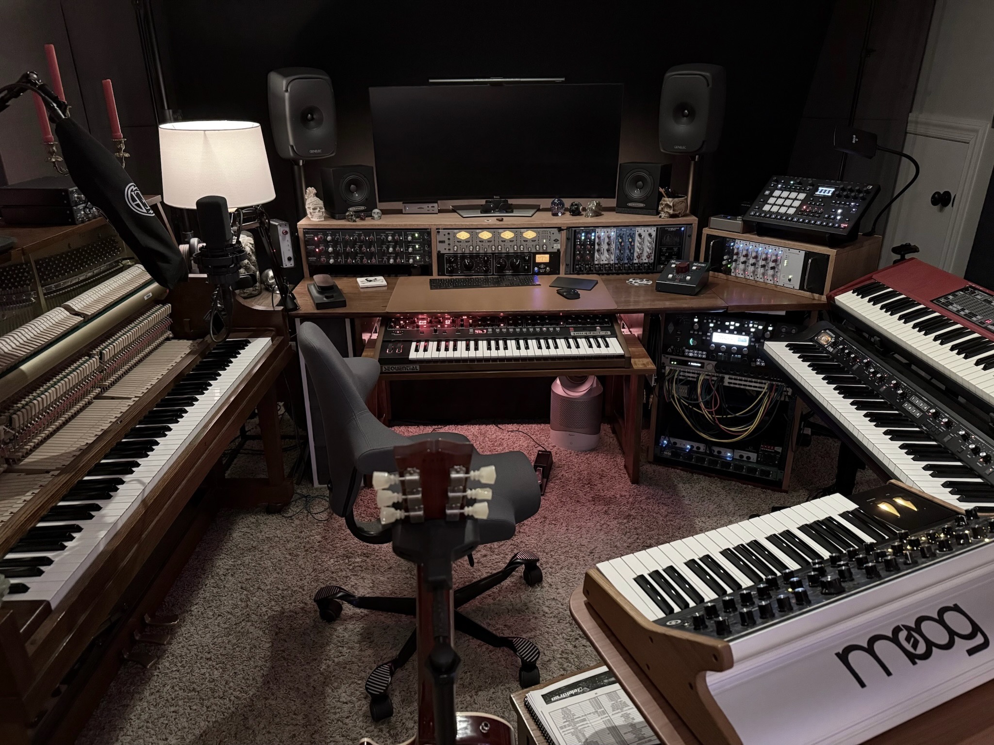 Centered view into Sweetflow Studio with piano, keyboards, monitors, and custom desk
