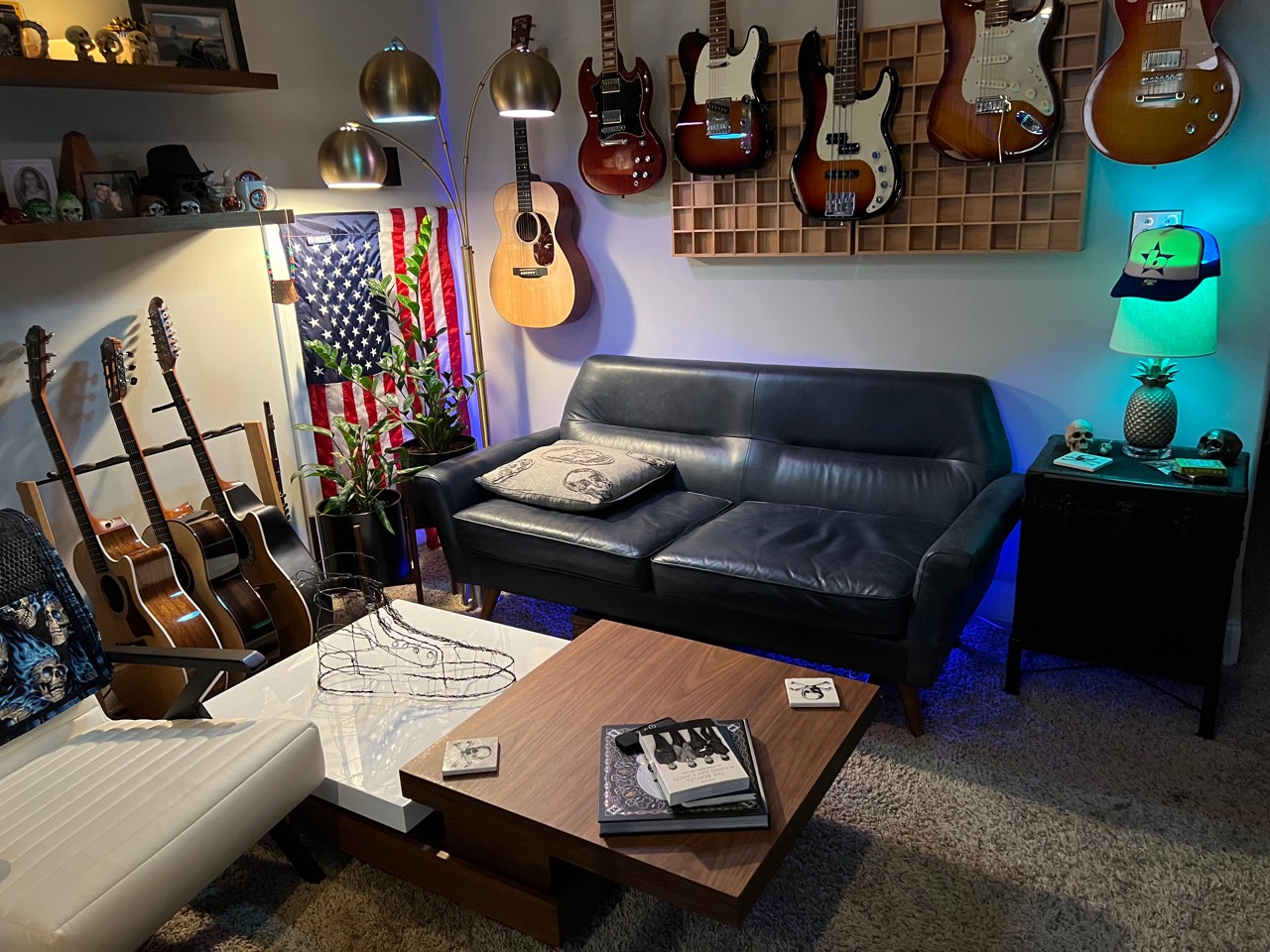 Sweetflow Studio guitar area with electric guitars, bass, steel-string acoustics, and the studio lounge